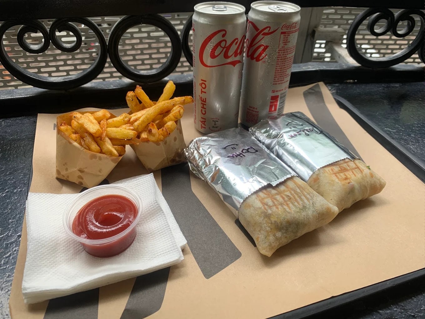 Grilled French tacos served with crispy fries, ketchup, and ice-cold Coke, a perfect quick meal combo for couple